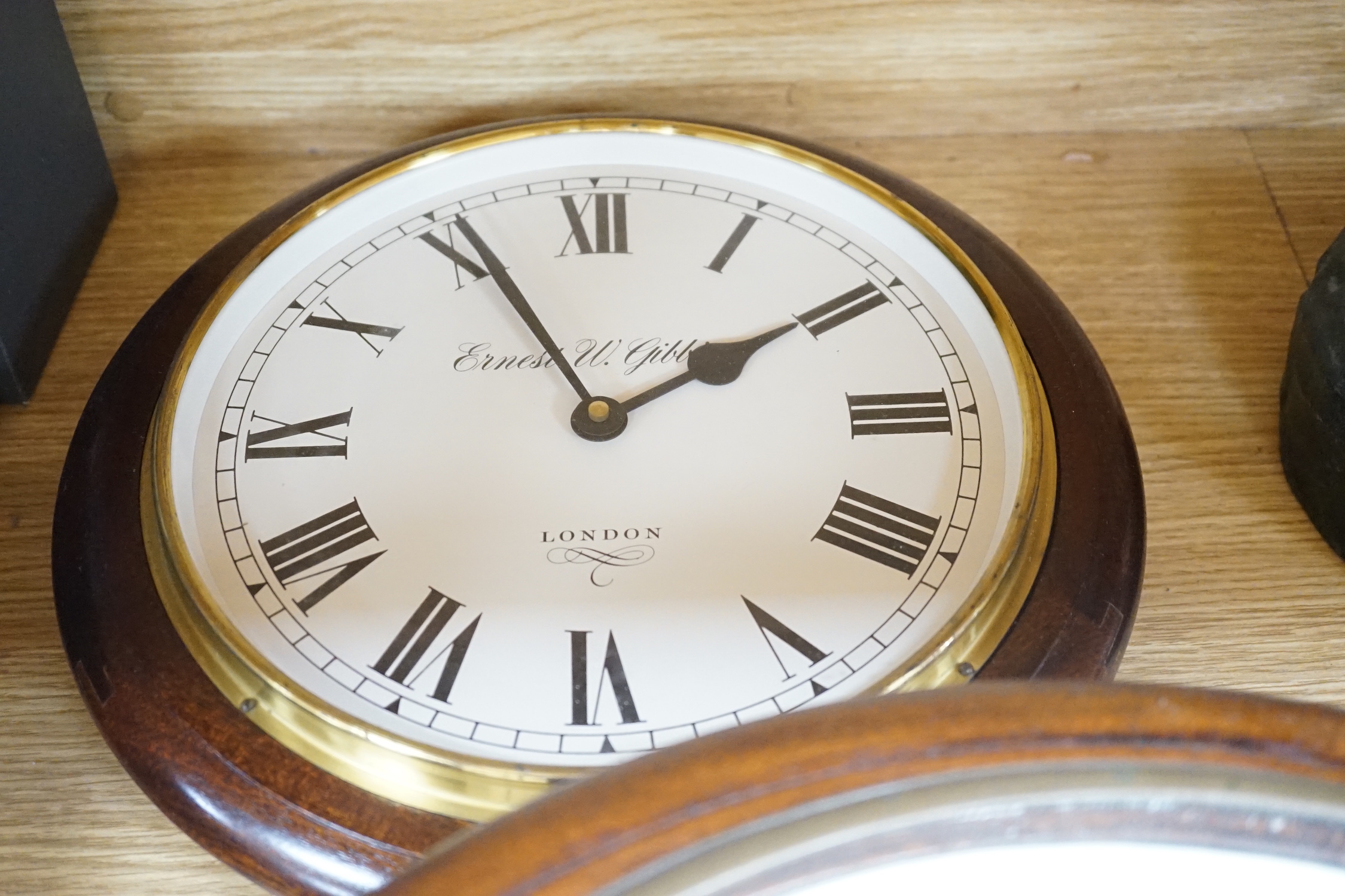 An Edwardian mahogany single fusee wall timepiece, The dial signed Warden Woolwich, the movement stamped Warren 1903/52 and later clock by Ernest N. Gibbs, London (2), largest 46cm diameter